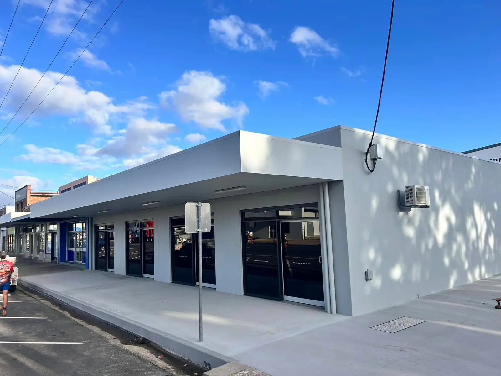 Completed commercial building frontage with covered walkway and shopfronts